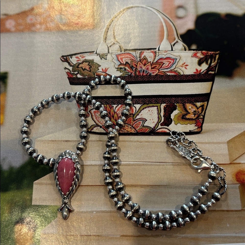 This is a Carolyn Pollack sterling silver elongated rhodochrosite pendant.